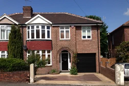 Curbsite angle of double height extension with garage